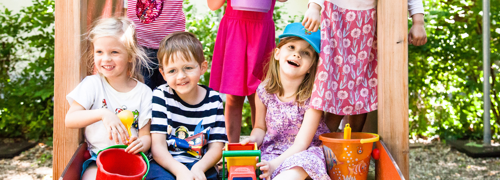 Kinder auf Rutsche im Garten