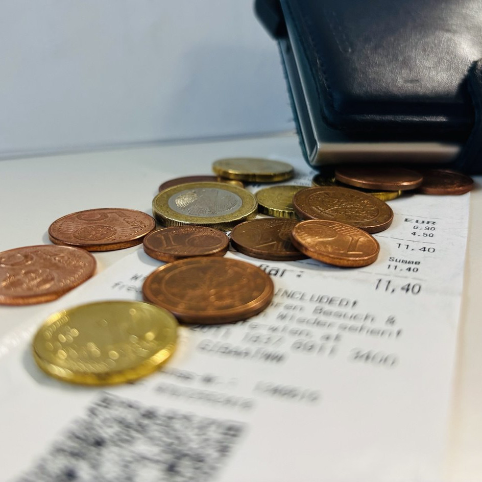 Münzen und Geldtasche auf einer Rechnung