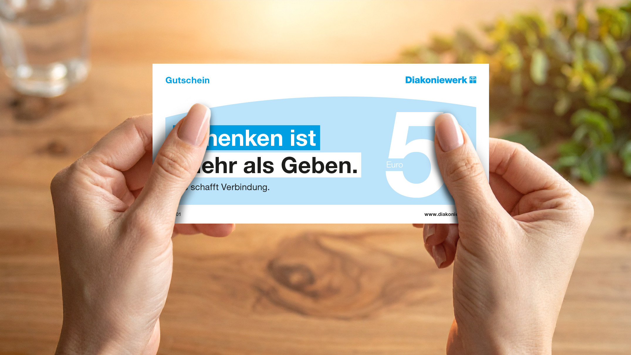 Hände halten einen Gutschein