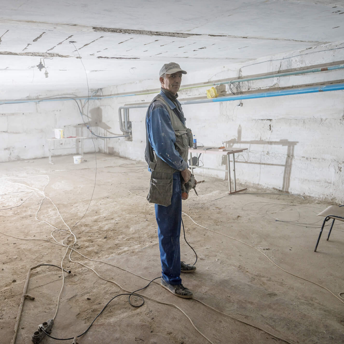 Ein Mann in einem kahlen Raum.